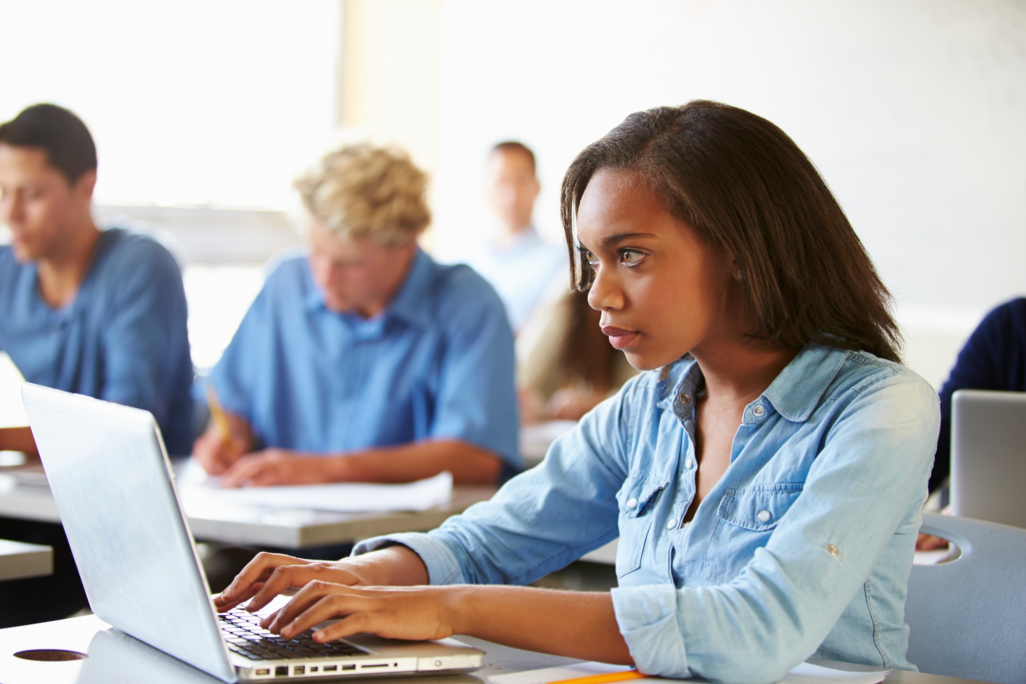 High School Students In Class Using Laptops